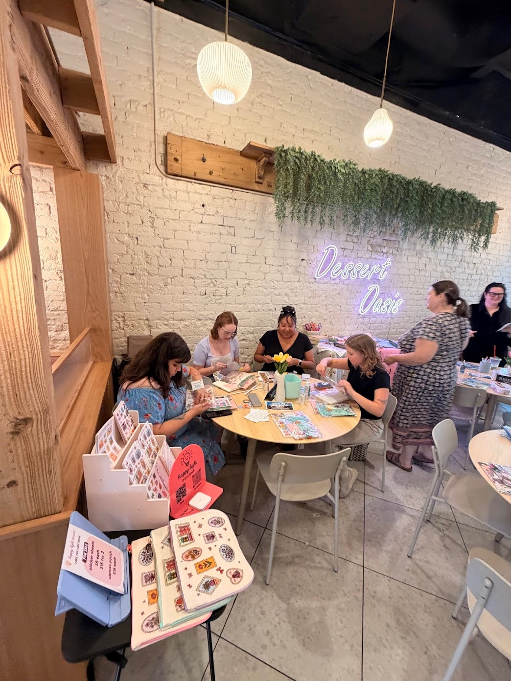Women crafting together around a table at a Gather and Glow Club event